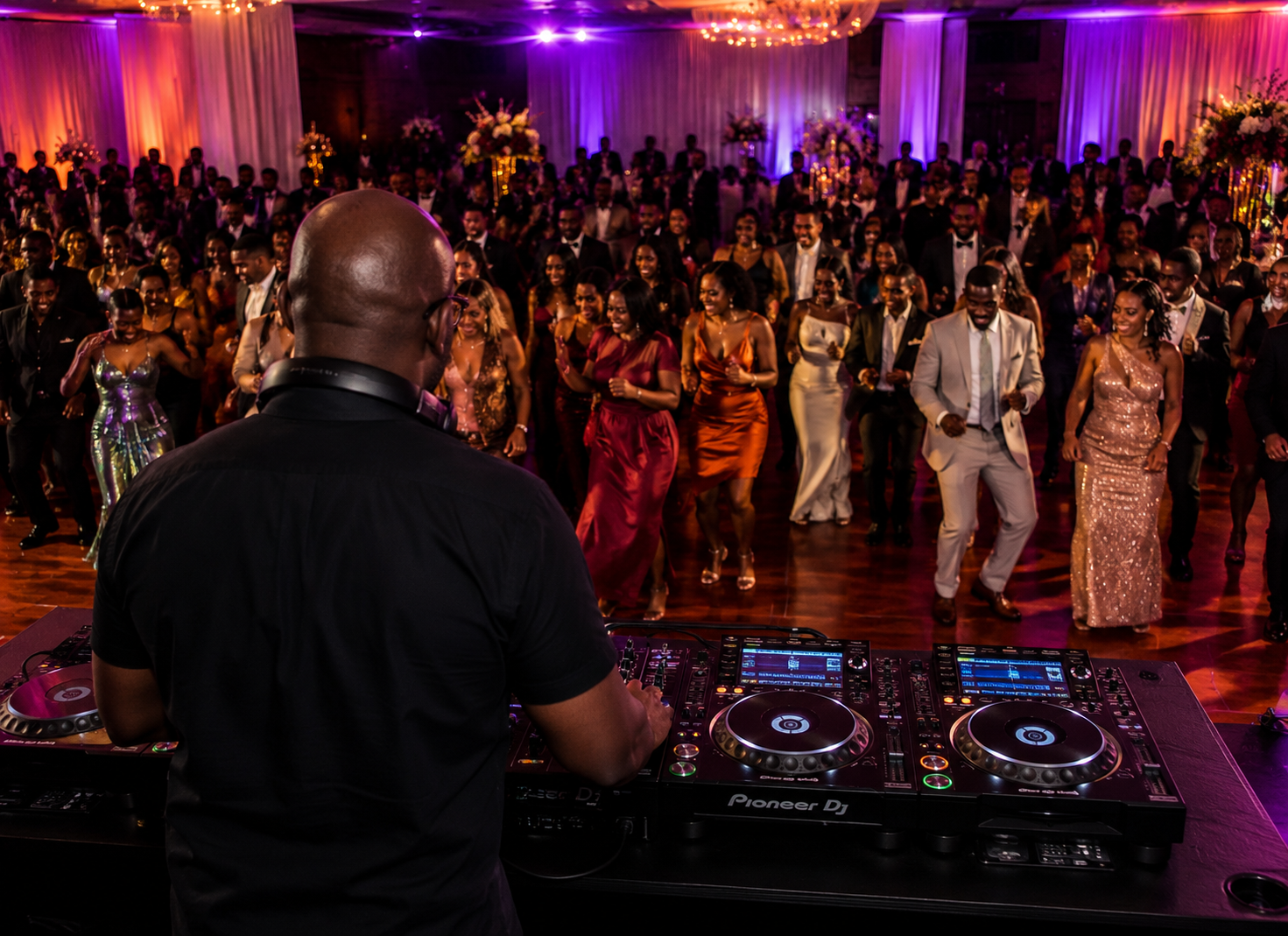 DJ Legendary behind the decks facing a full dance floor